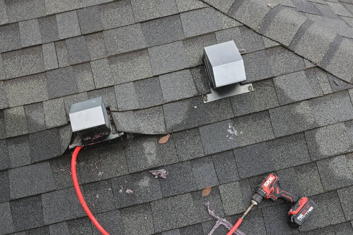 MedCity technician cleaning a rooftop dryer vent in Rochester, MN